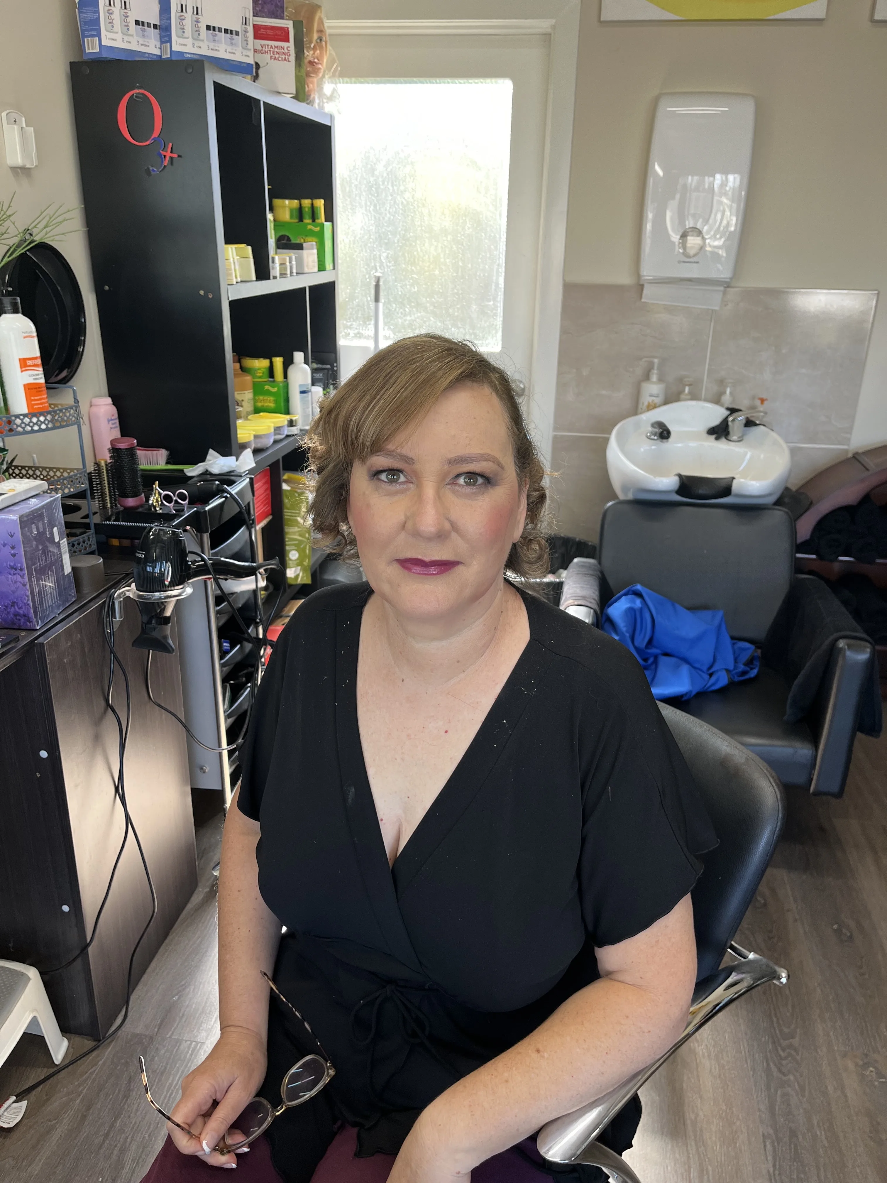 Client with completed makeup seated in the Fascino styling chair — on-premises result
