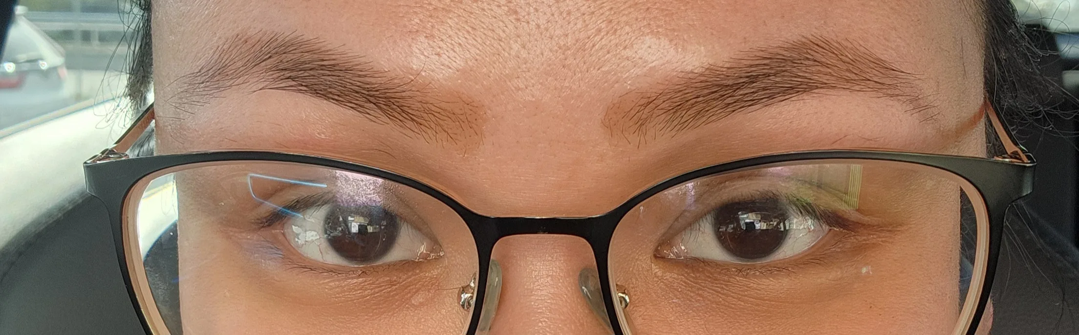 Close-up of a client's brows — genuine before-threading shot at Fascino