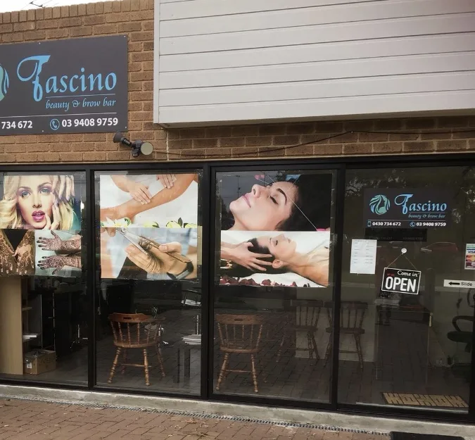 Fascino exterior — lit aqua-crest sign above the glazed frontage on Epping Road, OPEN sign visible